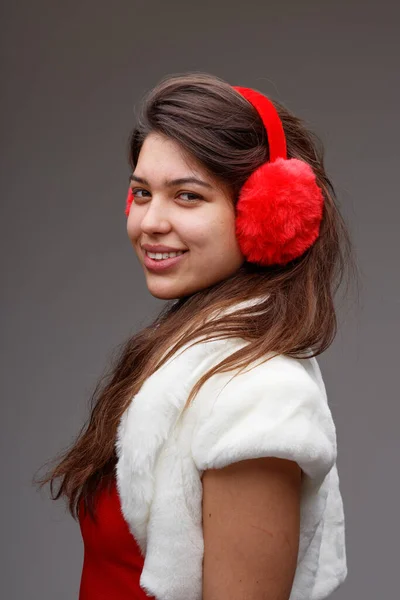 Young Woman Celebrating Christmas Festive Red Ear Muffs Fluffy White — Stock Photo, Image