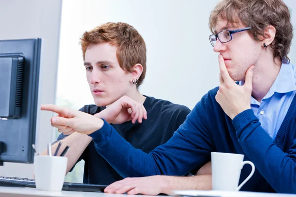 Young men working together in an office — Stock Photo, Image