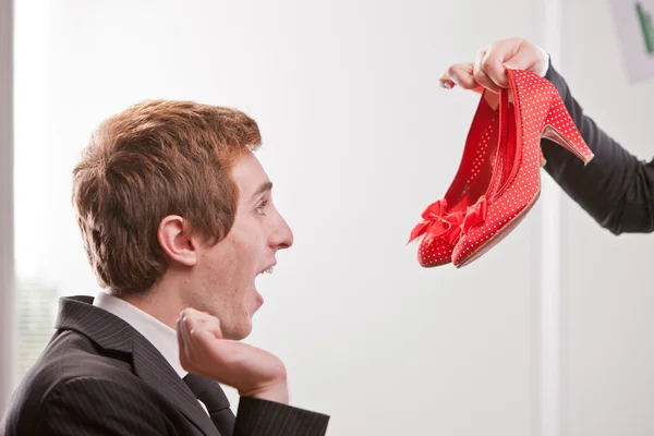 Redheaded guy loves red heels — Stock Photo, Image