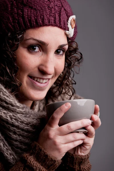 Young woman drinks something hot — Stock Photo, Image