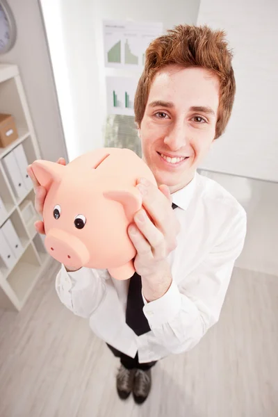 Wide angle of a clerk with a piggy bank — Stock Photo, Image