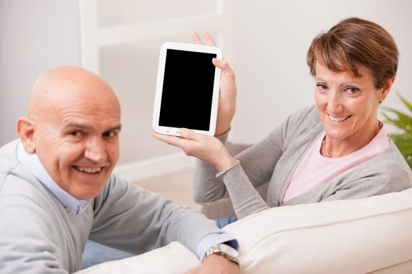 Mature couple using mobile devices — Stock Photo, Image