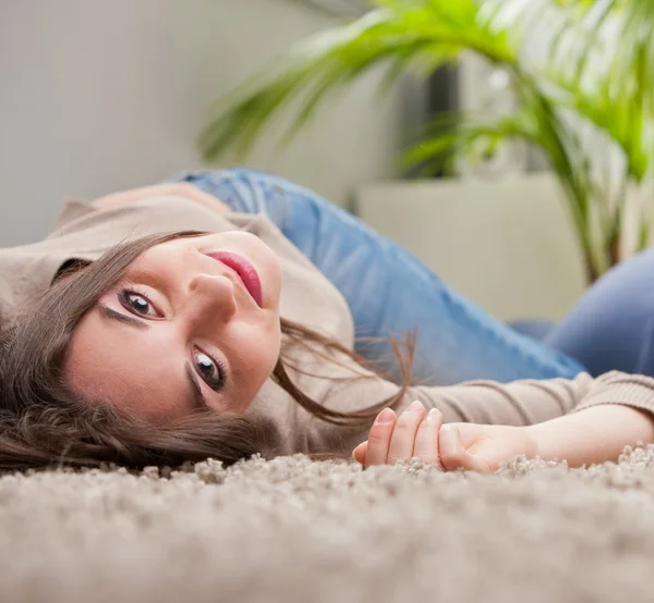 Woman smiling upside-down on the floor — Stock Photo, Image