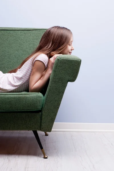 Little girl softly sleeping on a green sofa — Stock Photo, Image