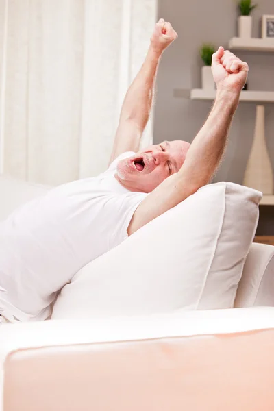 Man stretching and yawning at home — Stock Photo, Image