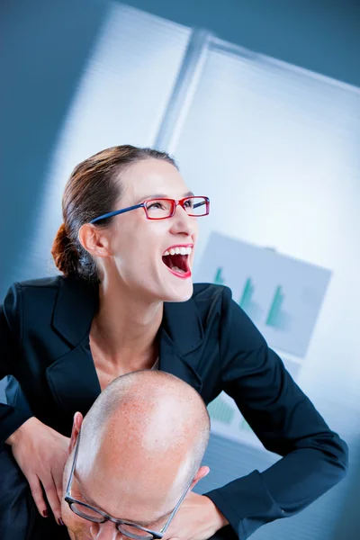 Mad businesswoman strangling a man — Stock Photo, Image