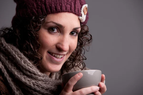 Smiling woman with a mugful of a hot drink — Stock Photo, Image