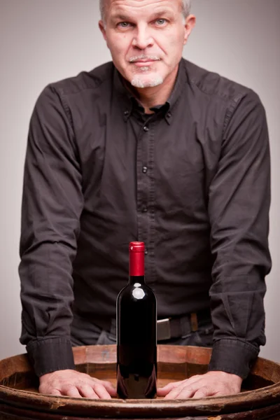 Proud wine maker man with a bottle — Stock Photo, Image