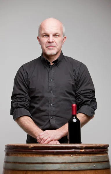 Proud wine maker man with a bottle — Stock Photo, Image
