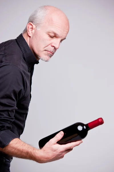 Proud wine maker man with a bottle — Stock Photo, Image