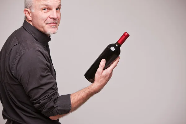 Proud wine maker man with a bottle — Stock Photo, Image