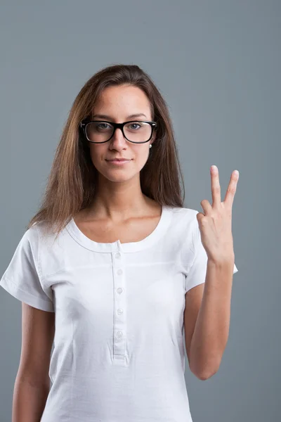 Beautiful girl showing number two with fingers of one hand — Stock Photo, Image