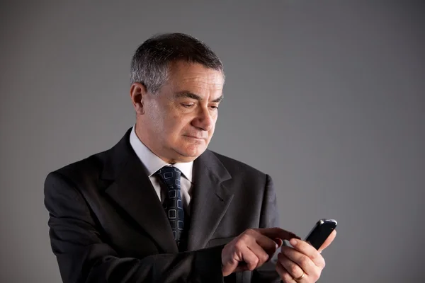 Eski bir cep telefonu kullanan adam — Stok fotoğraf