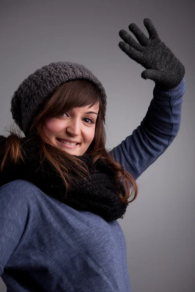 Girl waving at camera with warm hat scarf and gloves — Stock Photo, Image