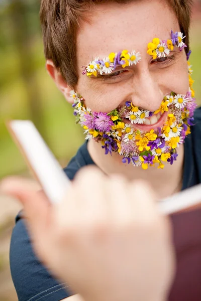Smiling hippy hipster reading face flower-covered — Stock Photo, Image