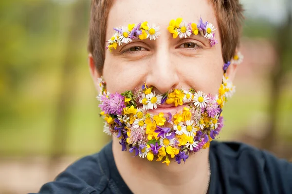 Happy man with flower beard and eyebrows — Stock Photo, Image