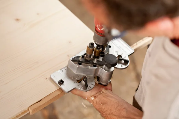 Carpenter placing a jig and piercing — Stock Photo, Image