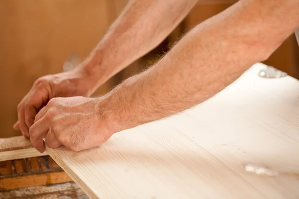 Man's hand working on wood — Stock Photo, Image