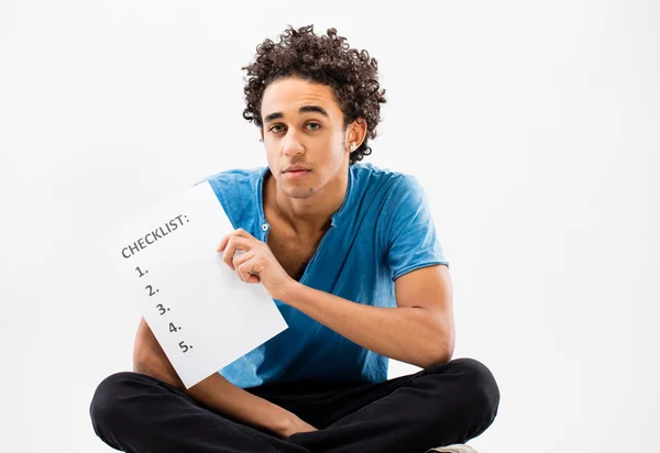 Smart guy shows a check list on a sheet — Stock Photo, Image