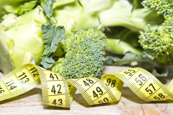 Vegetables and measuring tape — Stock Photo, Image