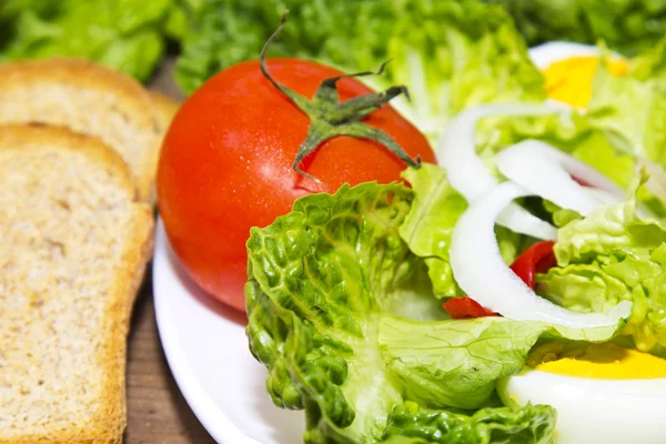 Salad plate and piece of bread — Stock Photo, Image