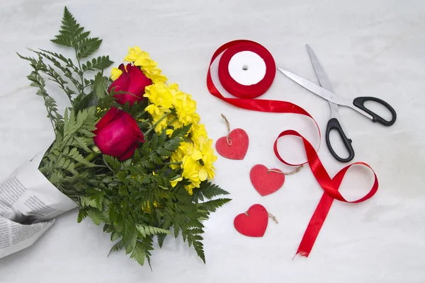 Bouquet of roses and daisies with scissors Stock Photo