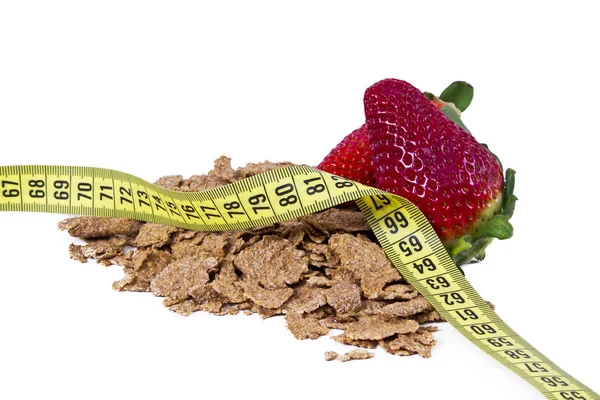 Cereal, strawberries and tape measure Stock Picture