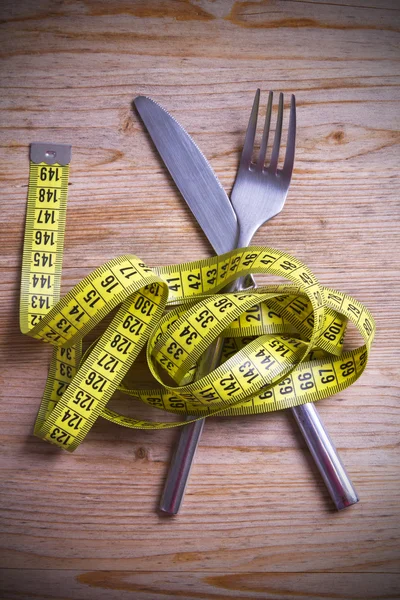 Covered table surrounded by tape measure — Stock Photo, Image