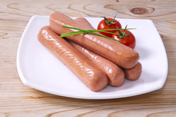 Sausages with tomato on the plate — Stock Photo, Image
