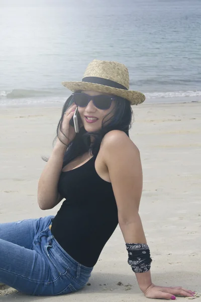 Femme avec téléphone portable sur la plage — Photo