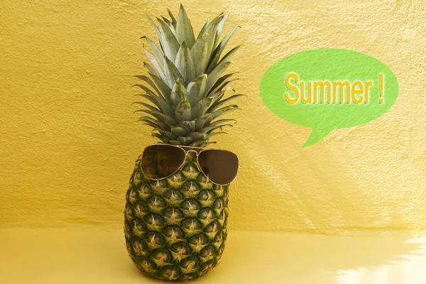 Pineapple with sunglasses on yellow background — Stock Photo, Image