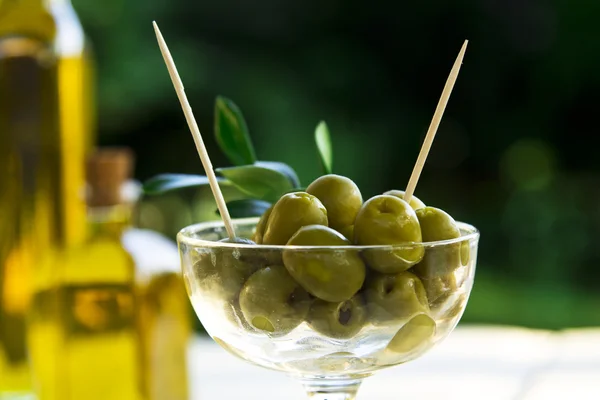 glass cup green olives stuffed with background field