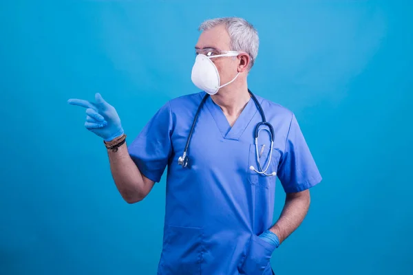 doctor with mask and glasses pointing or showing