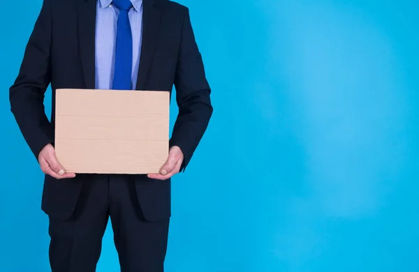 Businessman Holding Empty Poster Blue Background — Stock Photo, Image