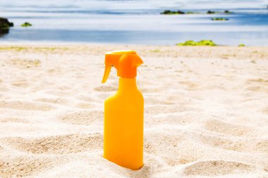 suntan lotion on the beach sand, summer vacation concept