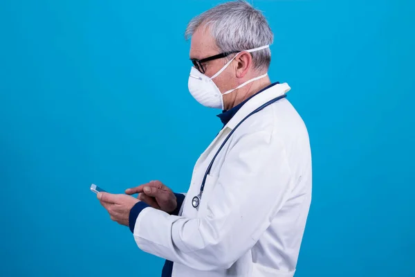 doctor with mask and mobile phone, concept of coronavirus virus and infections
