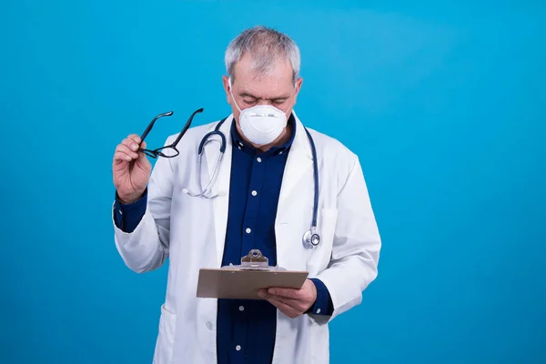doctor with mask, stethoscope and reports, coronavirus virus concept and infections