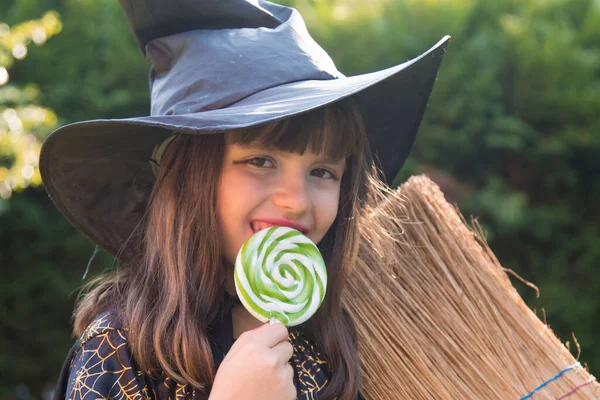 witch eating a candy lollipop, halloween party