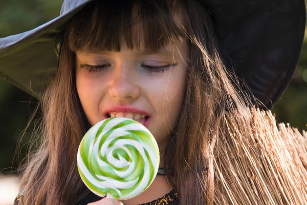 witch eating a candy lollipop, halloween party