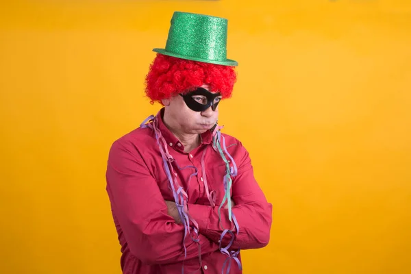 man disguised but overwhelmed and angry at the carnival party, concept of hatred of carnival