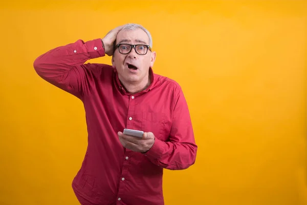 surprised or overwhelmed man with mobile phone