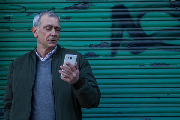 casual adult man checking his mobile phone with blind background