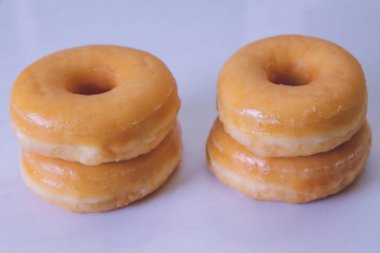 delicious sugary donuts on marbled white background