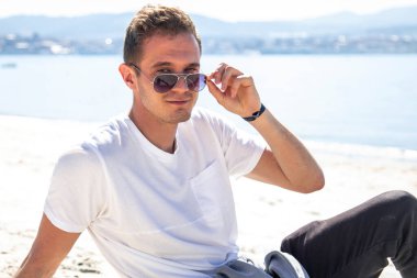 man in sunglasses relaxed on the beach