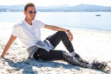 man in sunglasses relaxed on the beach