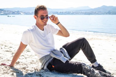 man in sunglasses relaxed on the beach
