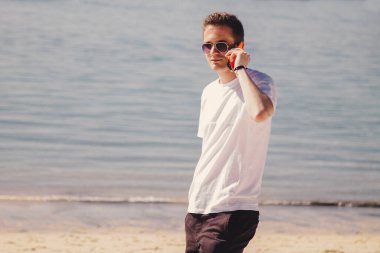 man walking on the beach and talking on mobile phone