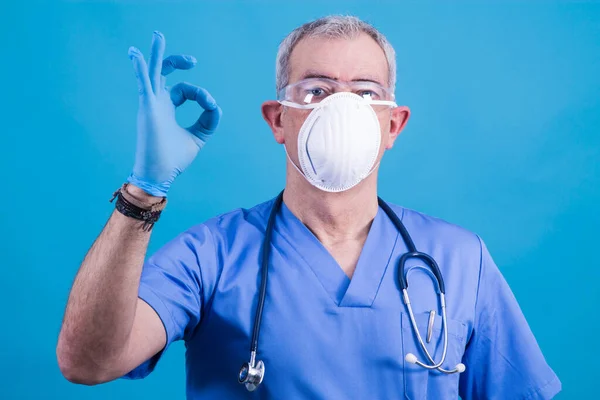 doctor with mask and stethoscope making ok sign