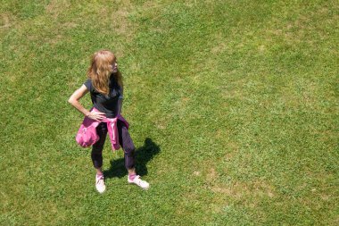 woman doing sport exercises on the city grass