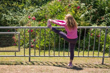 woman doing sport exercises in the city